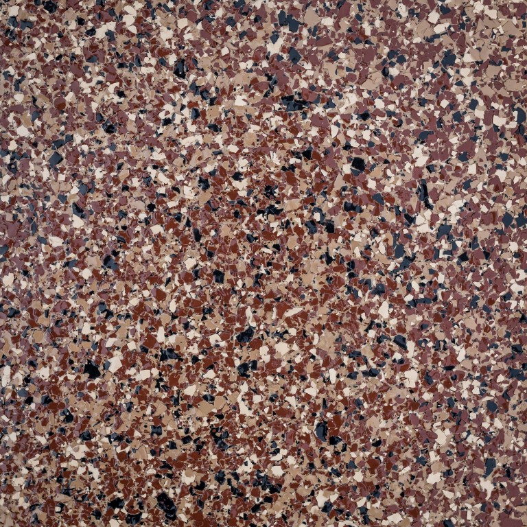 This image shows a close-up of a terrazzo floor pattern with various shades of brown, beige, and black chips scattered on a light background.