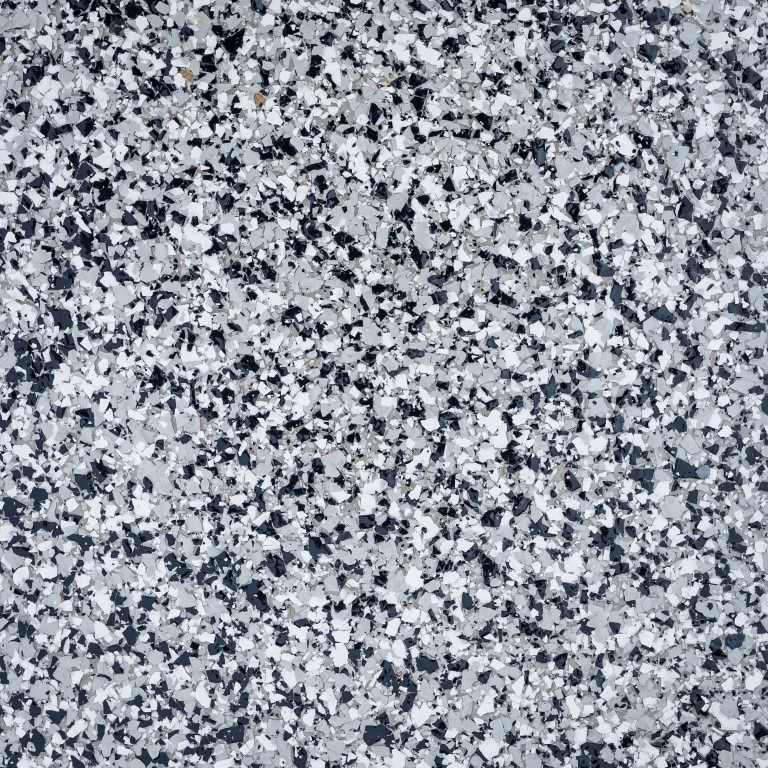 This image shows a speckled pattern of black, white, and gray, resembling a close-up of a terrazzo flooring or a similar composite material.