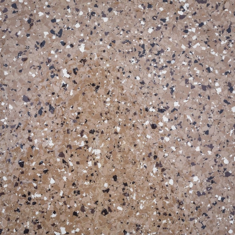 This image displays a close-up of a speckled surface, likely a terrazzo or granite with an array of beige, brown, white, and black fragments.
