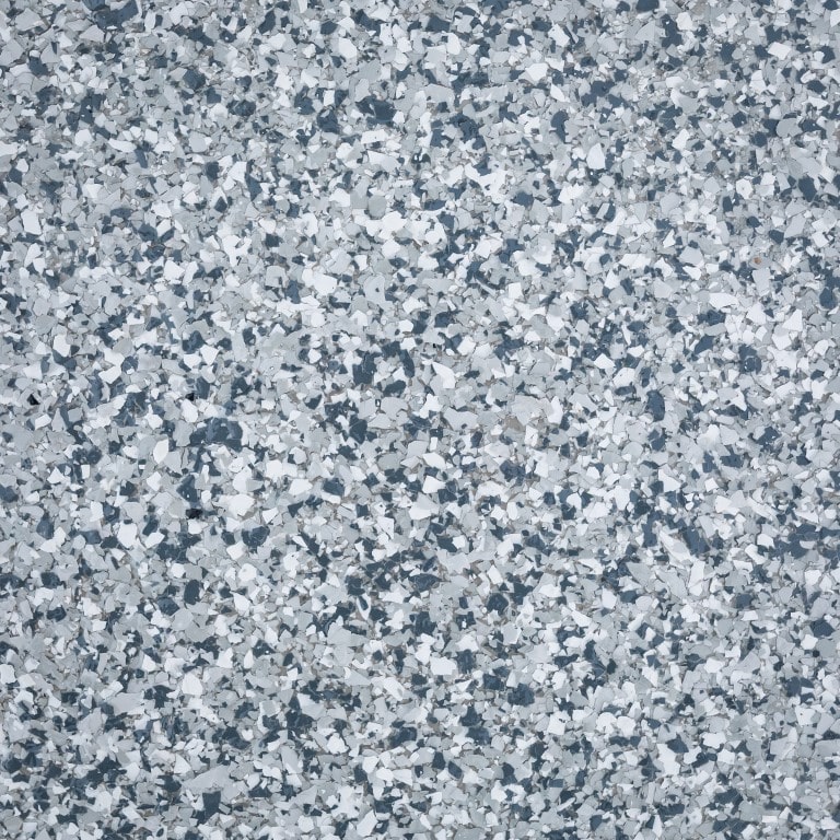 This image shows a close-up of a granular surface, consisting of various shades of gray, resembling a terrazzo floor or a composite material.