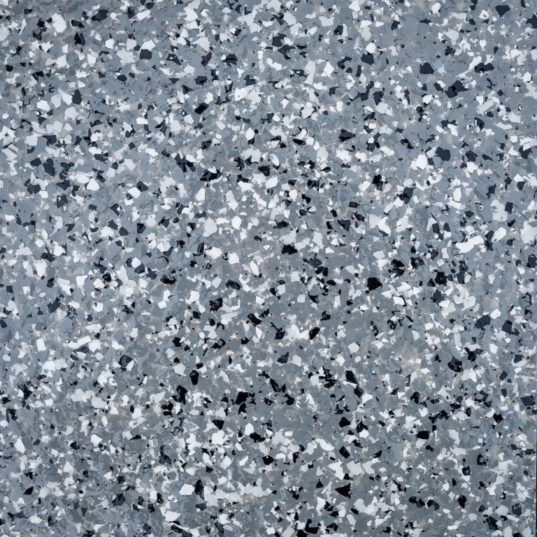 The image shows a terrazzo floor texture with a speckled pattern of various grey, white, and black stone fragments embedded in polished material.