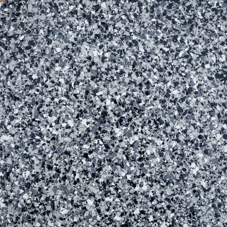 The image showcases a close-up texture of speckled granite with variations of white, gray, and black fragments uniformly distributed throughout the surface.